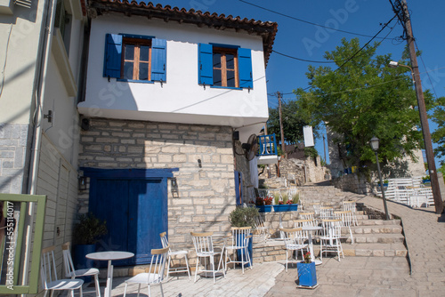 Traditional Greek restaurant with blue and white walls and window shutters in a Greek Village