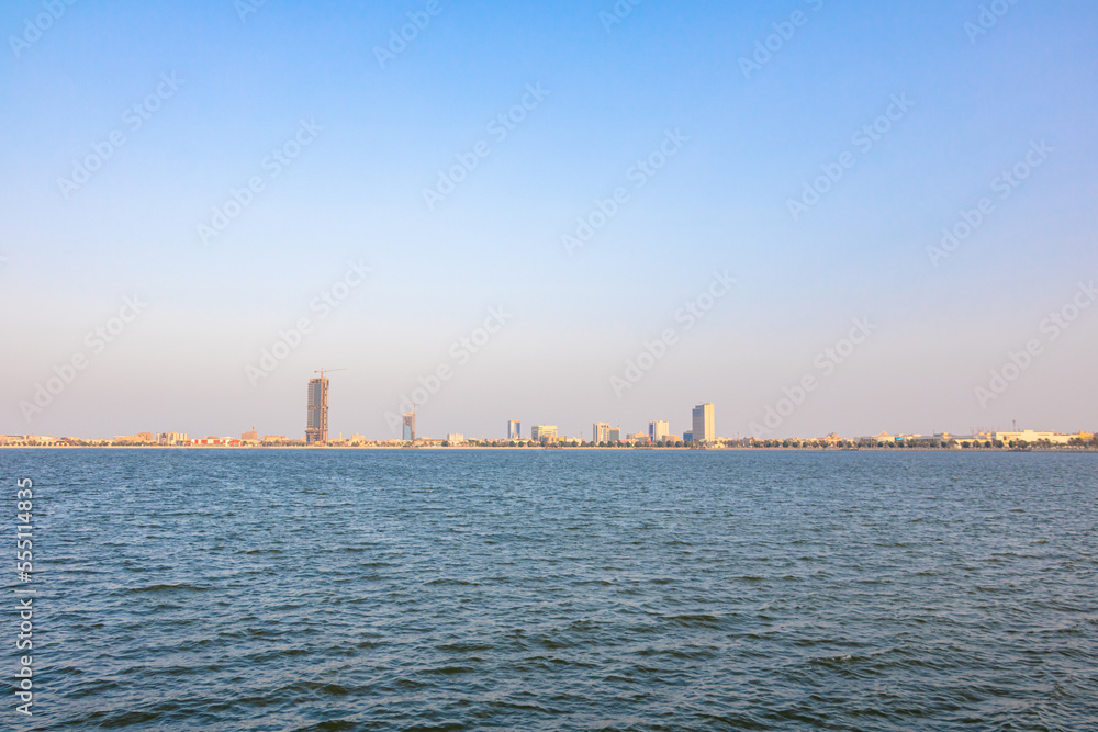 blue ocean with city skyline view