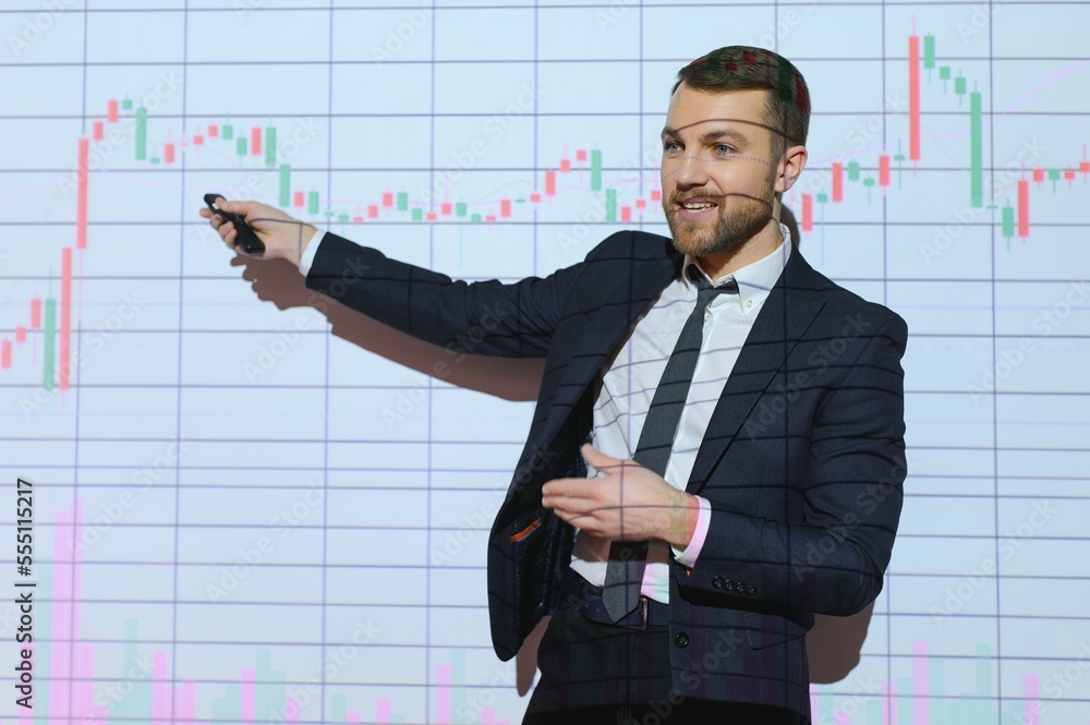 Trading teaching. Male leader talking to employees, showing the plan on the projector in office of stock exchange company. Trading teaching. Male leader talking to employees, showing the plan on the projector in office of stock exchange company.