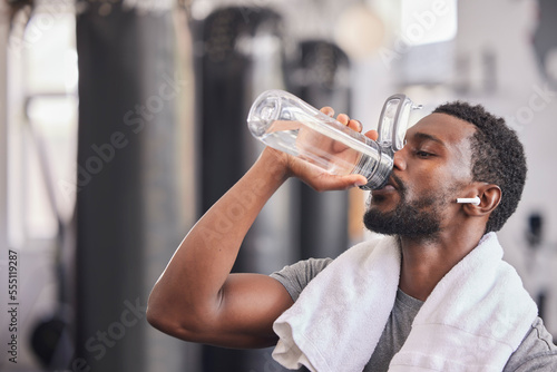 Fotografija Water bottle, tired black man in gym and resting after fitness workout, healthy sports exercise and muscle growth training