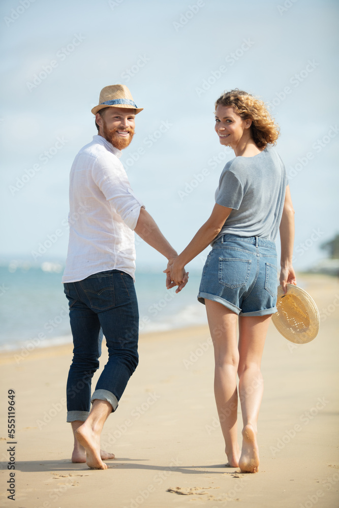 laughing couple in love holding hand enjoying in summertime laughing couple in love holding hand enjoying in summertime