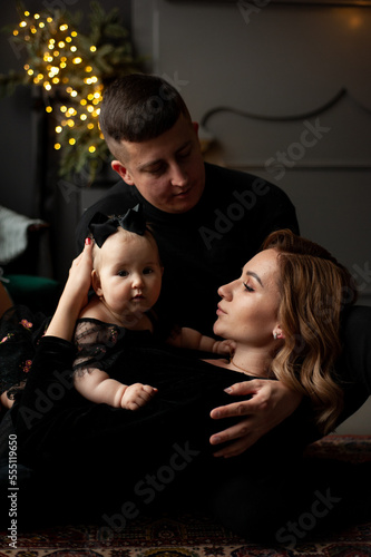Family portrait. Christmas mood. Dark background