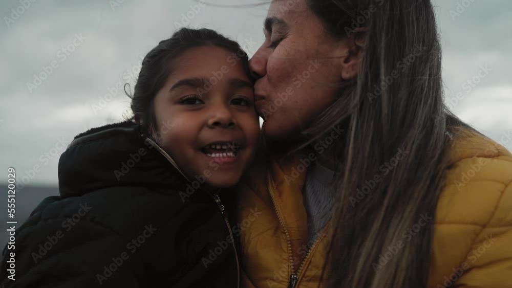 Happy Latin mother having a tender moment with her child during winter holidays - Family and love concept Happy Latin mother having a tender moment with her child during winter holidays - Family and love concept