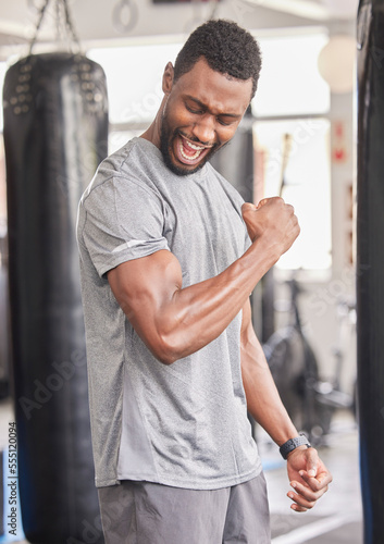 Fitness, gym and excited black man with muscle after workout, bodybuilder training and boxing exercise. Sports, power and strong male athlete flex biceps for muscular body, goals and achievement