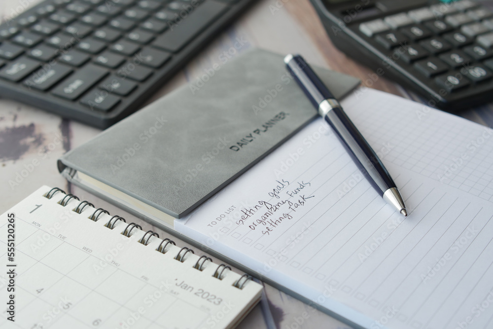 weekly planner and notepad on table weekly planner and notepad on table