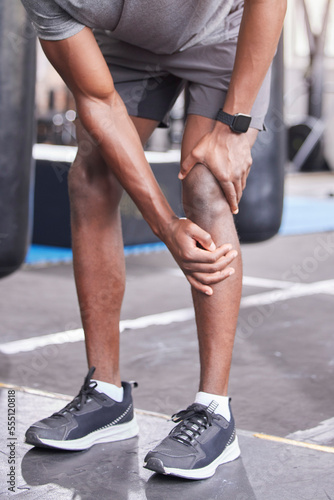 Fitness, injury and knee pain of black man at gym with inflammation problem resting legs. Joint pain, accident and cardio exercise person injured training at health club trauma assessment.