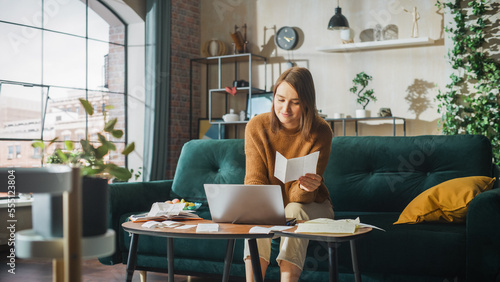 Happy Accounting at Home: Cheerful Smiling Woman Using Laptop Computer, Filling Tax Forms. Businesswoman Solving All His Paperwork Problems, Finishes the Job: Bills, Invoices, Has Financial Success