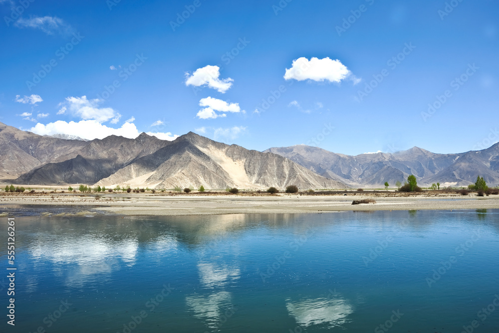 A beautiful view of a natural lake with water reflections of a bright sky, Tibet.