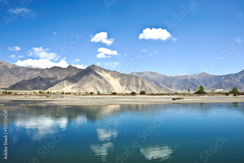 A beautiful view of a natural lake with water reflections of a bright sky, Tibet.