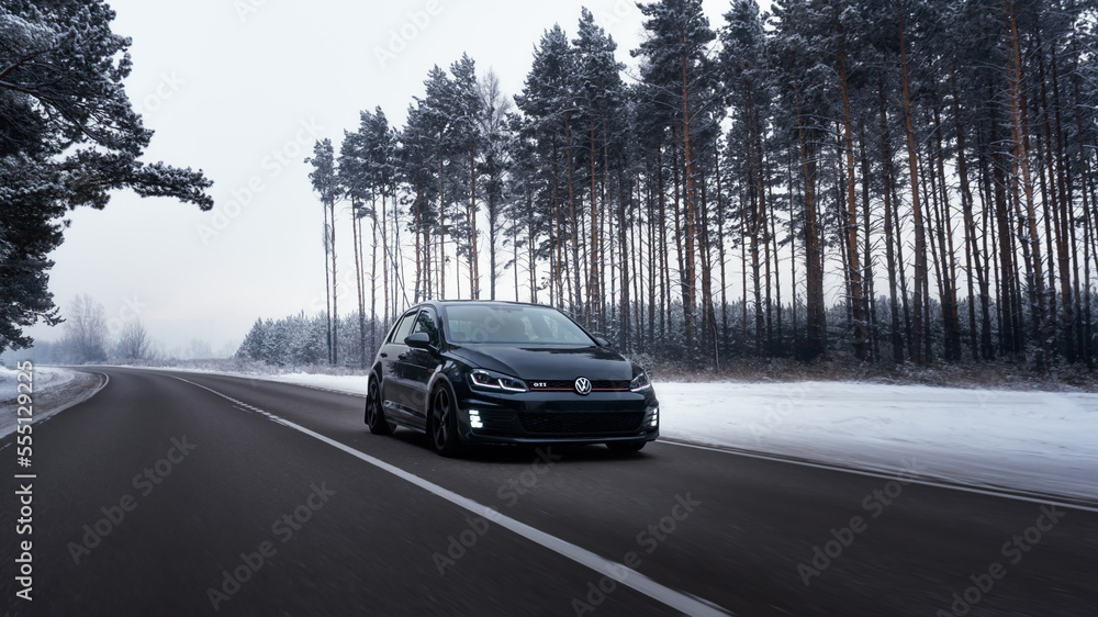Helsinki Finland December 15 2022 Volkswagen Golf Mk7 GTI on the road in the forest in snowy winter Stock Foto Adobe Stock