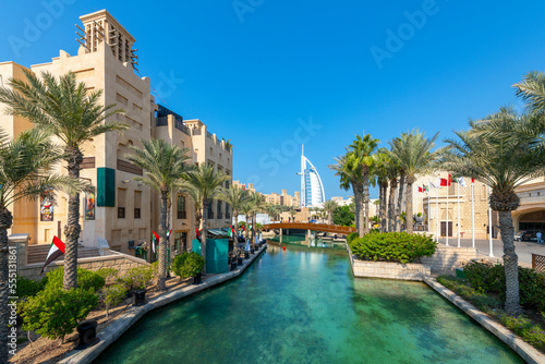 Photography The Burj Al Arab hotel is seen over the canal and shops of the Souk Madinat Jumeirah, an upscale shopping market and mall in Dubai, United Arab Emirates
