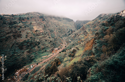 a scenic view of a valley with a road going through it