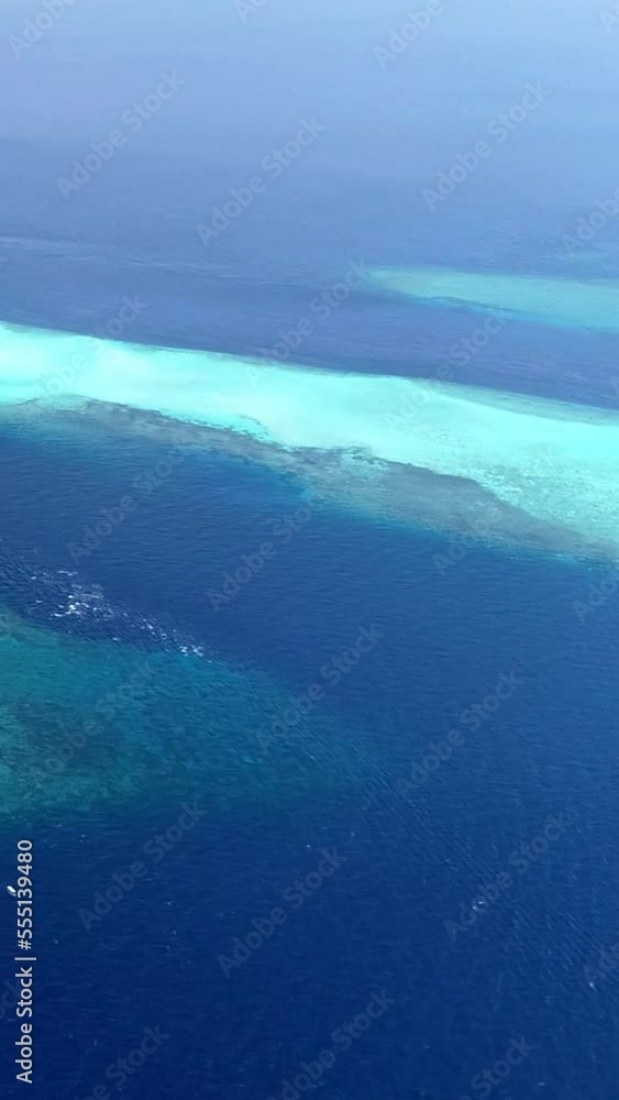 Vertical video of Aerial shot of tropical rocky island with turquoise water and shallow reef Vertical video of Aerial shot of tropical rocky island with turquoise water and shallow reef