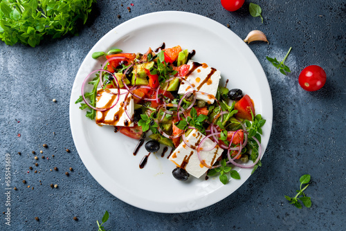 Greek salad with feta and fresh vegetables top view
