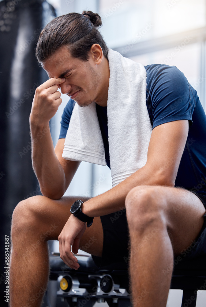 Man, gym exercise and tired with headache at training, workout or wellness studio with anxiety. Bodybuilder, fitness and burnout while sitting for stress, rest or relax after weightlifting in Toronto Man, gym exercise and tired with headache at training, workout or wellness studio with anxiety. Bodybuilder, fitness and burnout while sitting for stress, rest or relax after weightlifting in Toronto