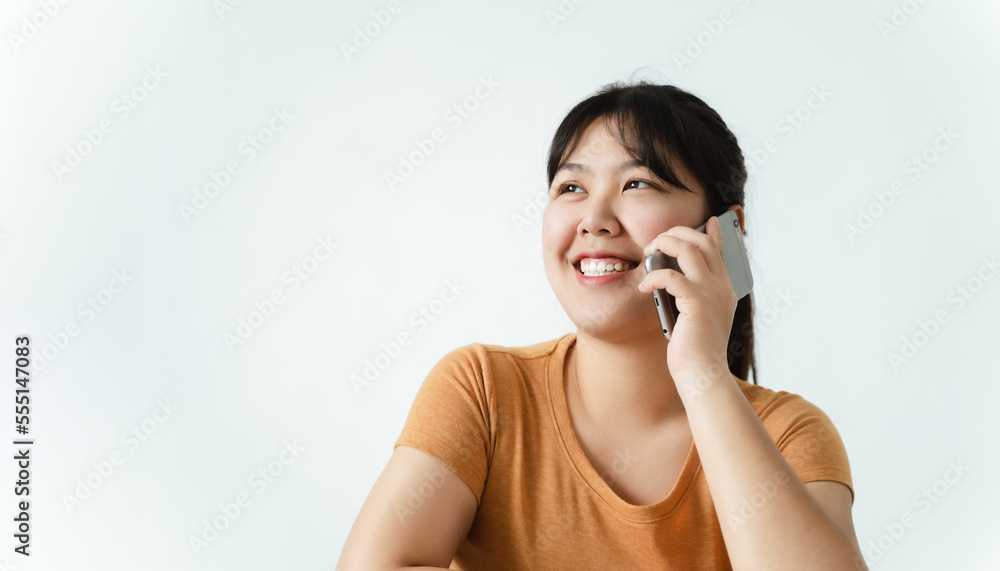 Fototapeta premium Pretty young Asian woman having phone conversation with copy space.