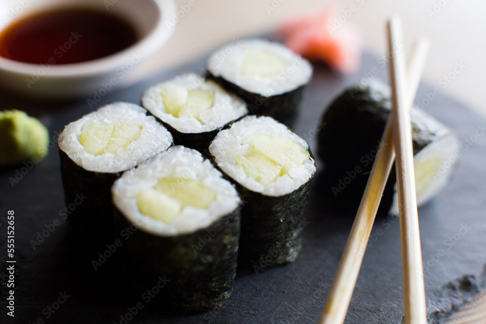 Vegan Maki sushi with rice and seaweed stuffed with vegetables and vegetarian ingredients. Vegan Maki sushi with rice and seaweed stuffed with vegetables and vegetarian ingredients.