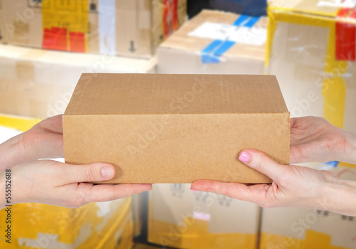 Hands with cardboard box. P...