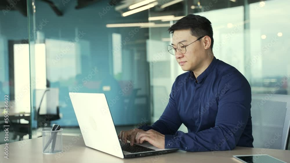 Sleepy tired businessman IT programmer with glasses having long day working on computer in the office Unmotivated asian worker entrepreneur trying to typing texting and browsing on keyboard at desk Sleepy tired businessman IT programmer with glasses having long day working on computer in the office Unmotivated asian worker entrepreneur trying to typing texting and browsing on keyboard at desk