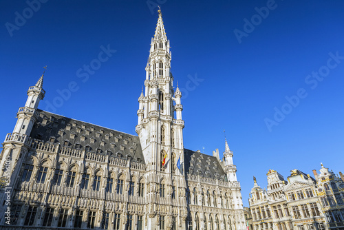 Town Hall of the city of Brussels, a large, decorative building in city square with gold trim and blue sky; Brussels, Belgium photo