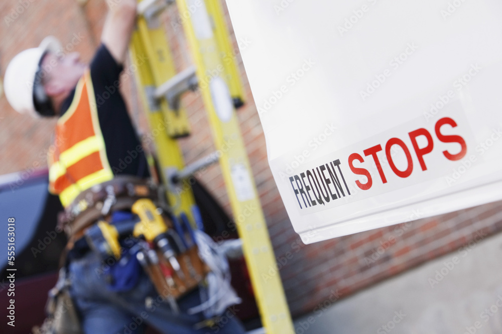Lineman climbing a ladder Stock Photo | Adobe Stock