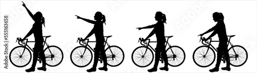 The cyclist is standing next to the bike. A girl with the bicycle holds the handlebars of the bicycle with her hand, with the other hand she shows the direction: up, down, sideways. Isolated on white