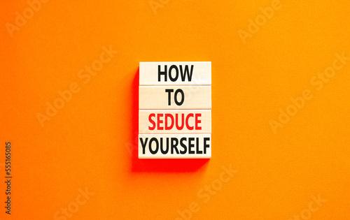 How to seduce yourself symbol. Concept word How to seduce yourself on wooden blocks. Beautiful orange table orange background. Business and how to seduce yourself concept. Copy space.