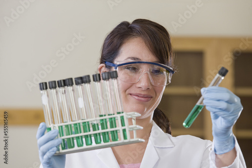 Lab technician analyzing a sample in test tube photo