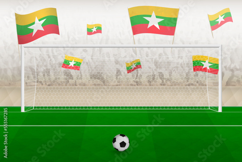 Myanmar football team fans with flags of Myanmar cheering on stadium, penalty kick concept in a soccer match.
