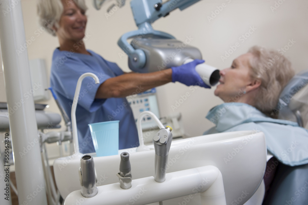 Female dentist taking X-Ray of her patient Female dentist taking X-Ray of her patient