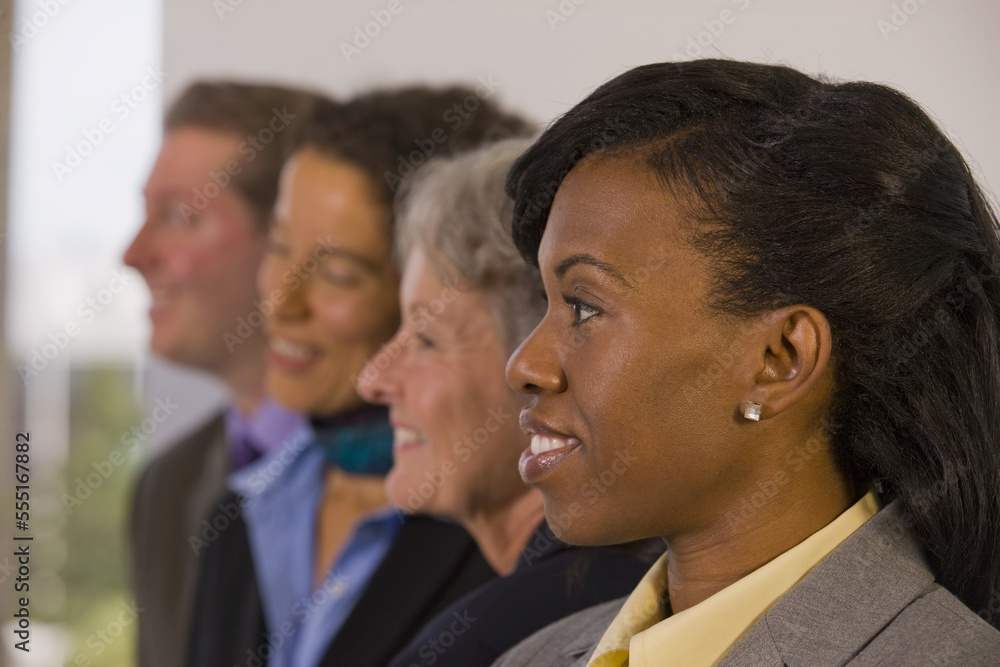 Team of business people with three business women and one business man standing in a row Team of business people with three business women and one business man standing in a row