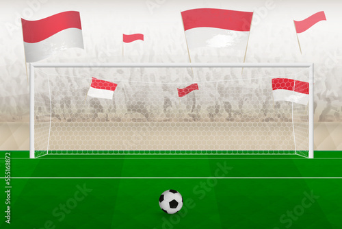 Monaco football team fans with flags of Monaco cheering on stadium, penalty kick concept in a soccer match.