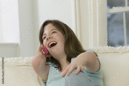 Teenage girl with birth defect talking on a mobile phone photo