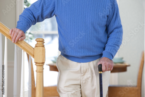 Man with Parkinson's disease and multiple sclerosis standing near steps photo