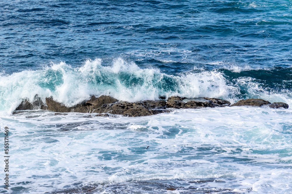 waves crashing against the rocks in the atlantic ocean in the town of Baiona, Galicia, Spain