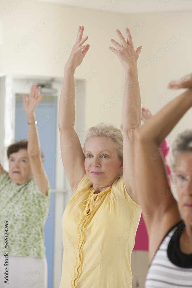 Exercise class for seniors with women stretching Exercise class for seniors with women stretching