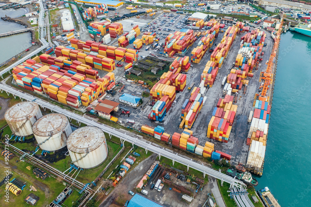 Containers in cargo freight port, aerial view. Industrial harbor, global transportation and international logistic business concept.