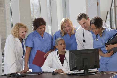 Doctors and nurses consulting on a computer in hospital photo