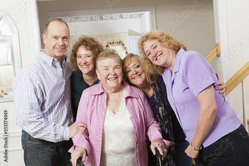 Portrait of a happy elderly woman with walker and her adult children