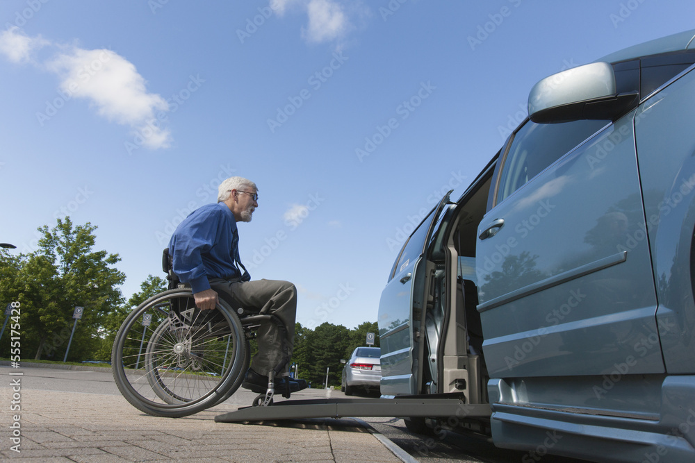 Man with muscular dystrophy and diabetes getting in an accessible van Man with muscular dystrophy and diabetes getting in an accessible van