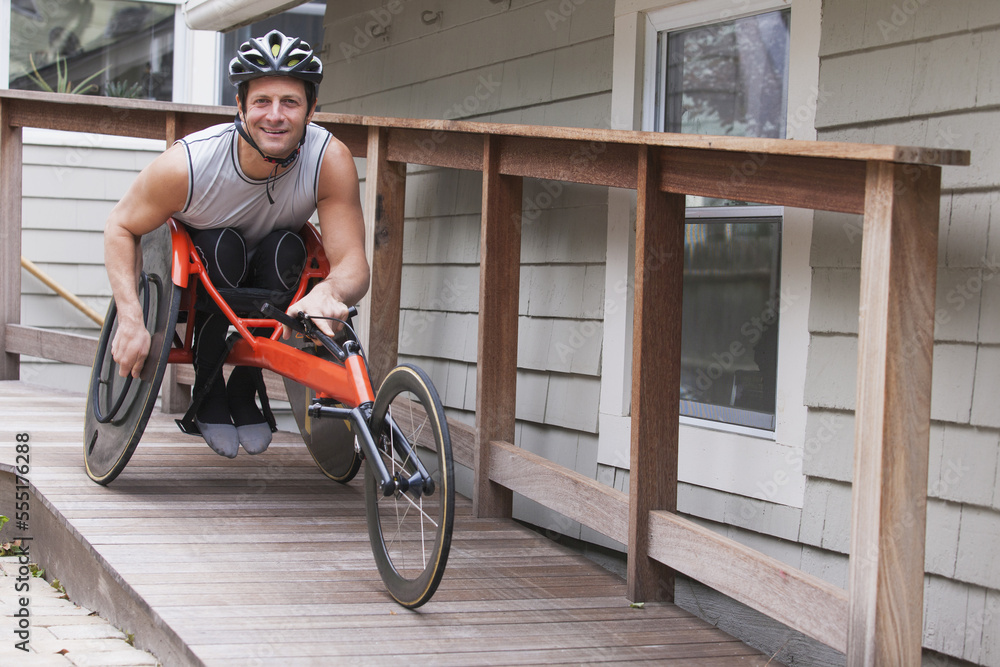 Man with spinal cord injury in disability racing bike Man with spinal cord injury in disability racing bike