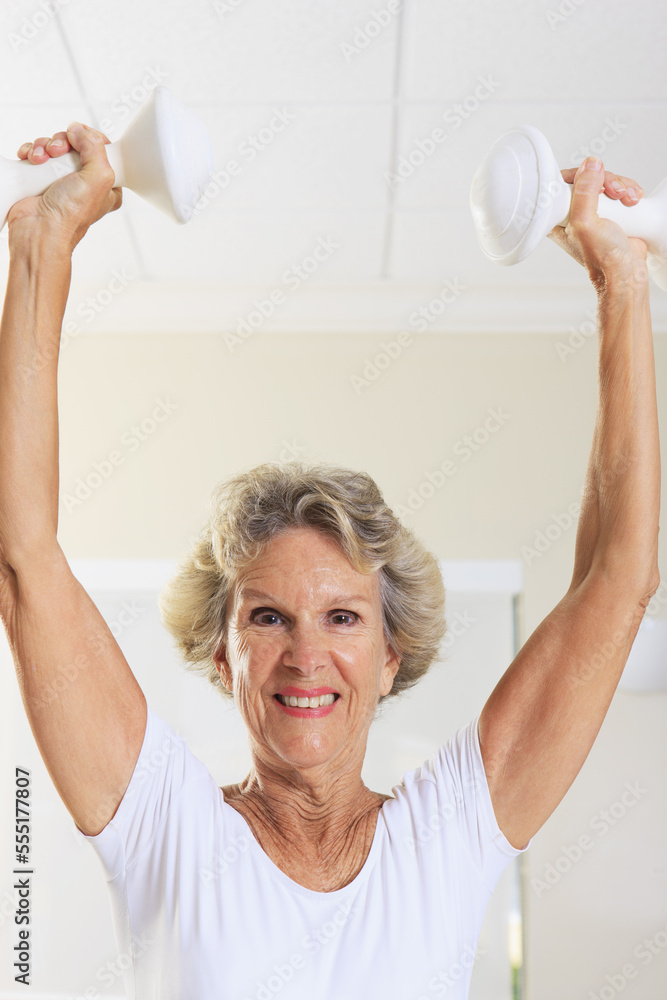 Portrait of a senior woman exercising with weights