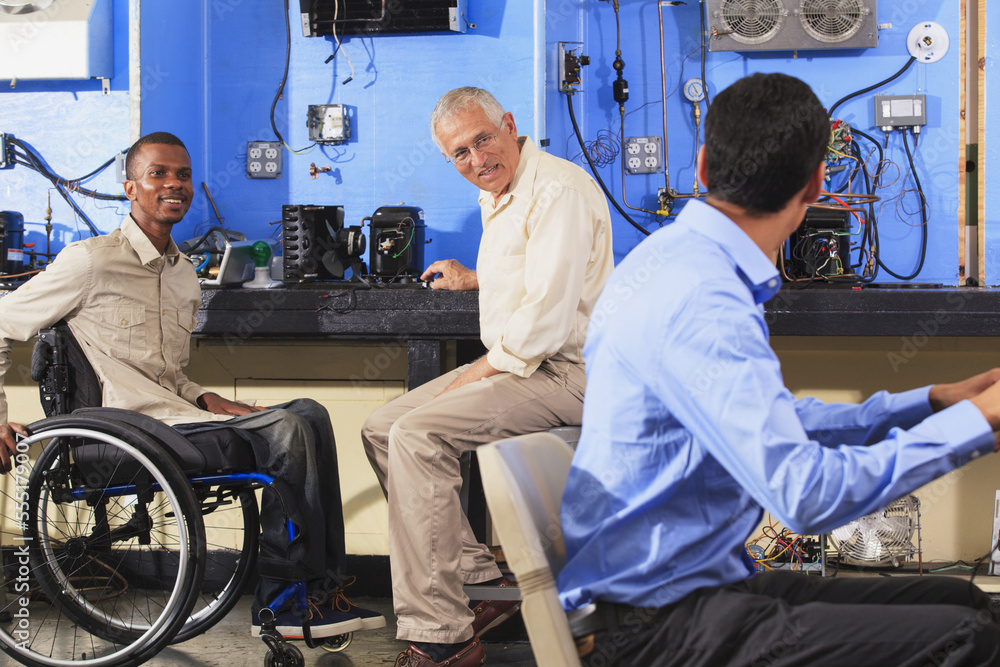 Instructor discussing HVAC system operation with students one student