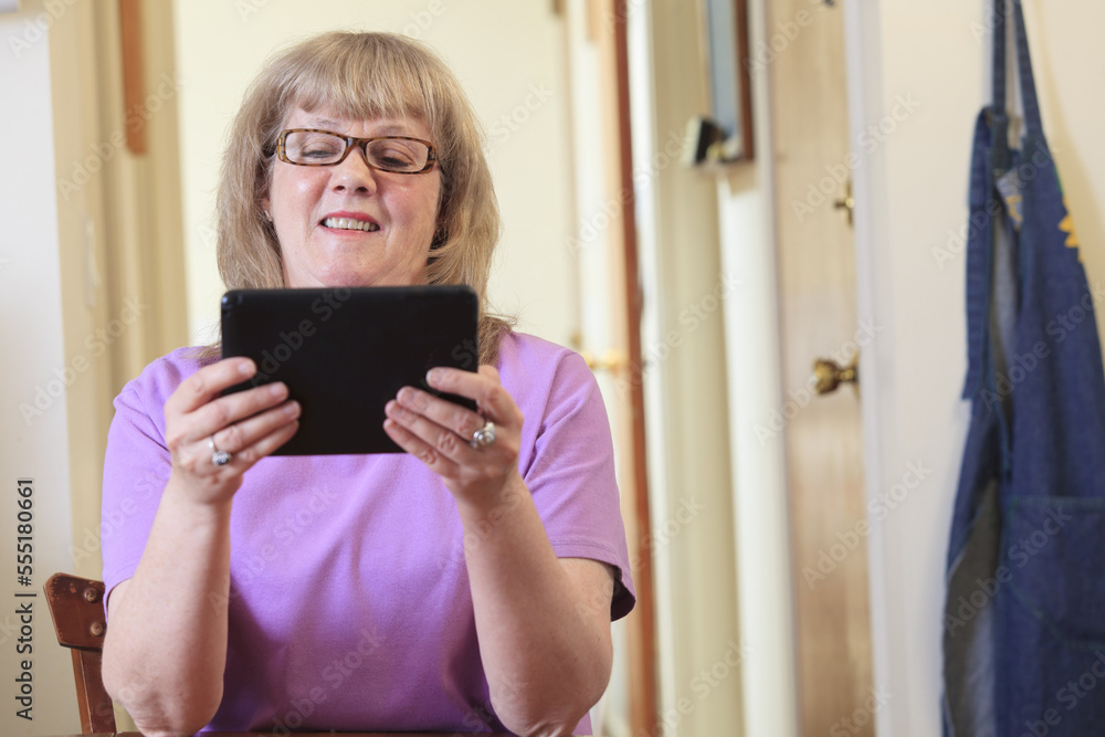 Woman with Bipolar disorder living at home and using her tablet Woman with Bipolar disorder living at home and using her tablet