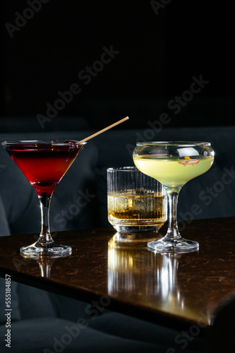 alcoholic cocktails on the stone table in the bar