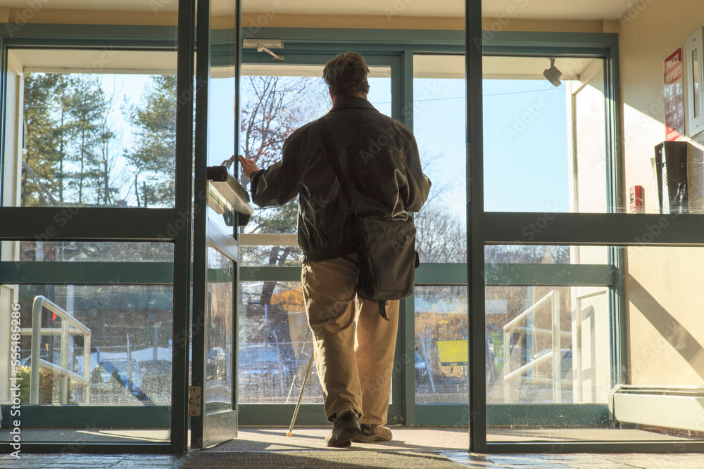 Man with congenital blindness leaving his apartment building Man with congenital blindness leaving his apartment building