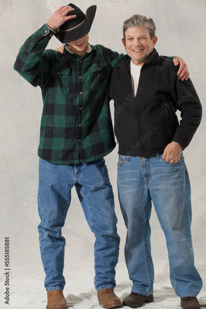 Young man with autism adjusting his hat with his mentor arm in arm Young man with autism adjusting his hat with his mentor arm in arm