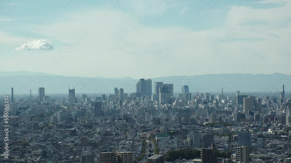 NAGOYA, JAPAN - OCTOBER 2022 : Aerial high angle view of NAGOYA CITY in sunny daytime. View of buildings and street traffic around Nagoya station and Sakae area (central downtown). Time lapse shot. NAGOYA, JAPAN - OCTOBER 2022 : Aerial high angle view of NAGOYA CITY in sunny daytime. View of buildings and street traffic around Nagoya station and Sakae area (central downtown). Time lapse shot.