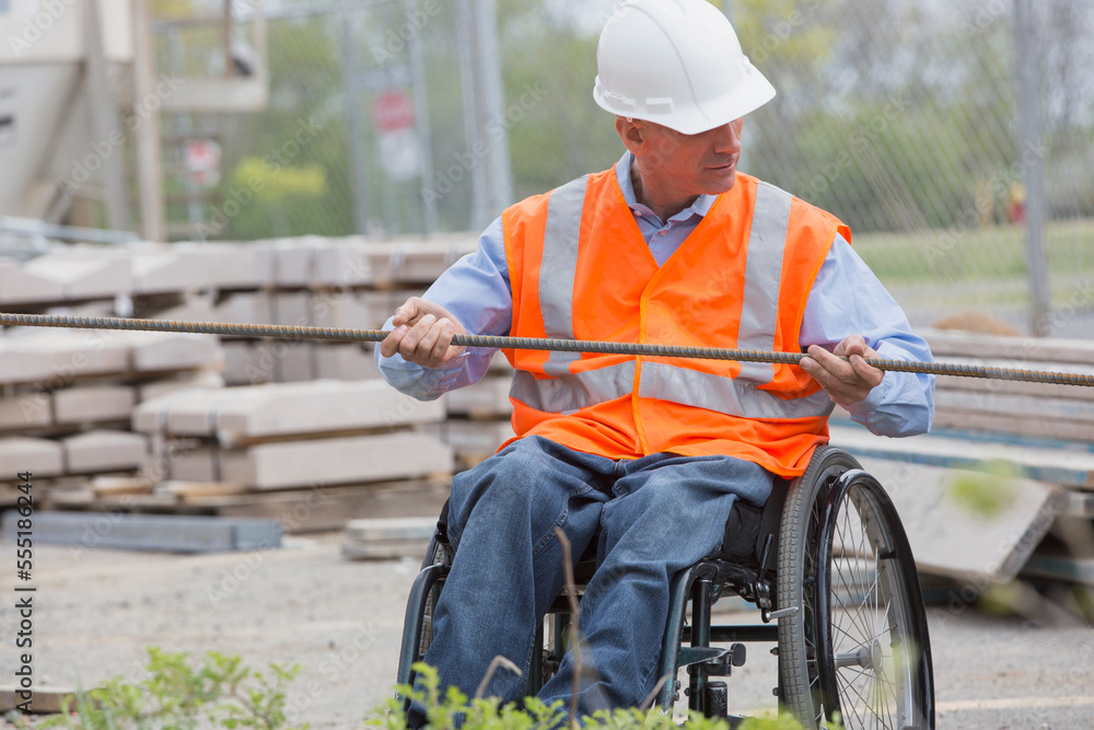 Project engineer with a Spinal Cord Injury in a wheelchair at job site Project engineer with a Spinal Cord Injury in a wheelchair at job site