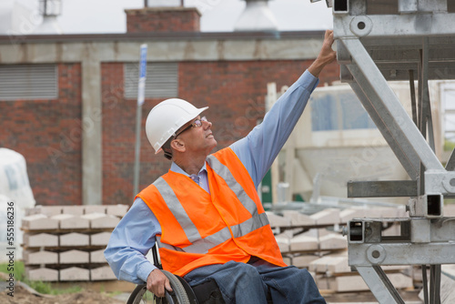 Project engineer with a Spinal Cord Injury in a wheelchair at job site photo